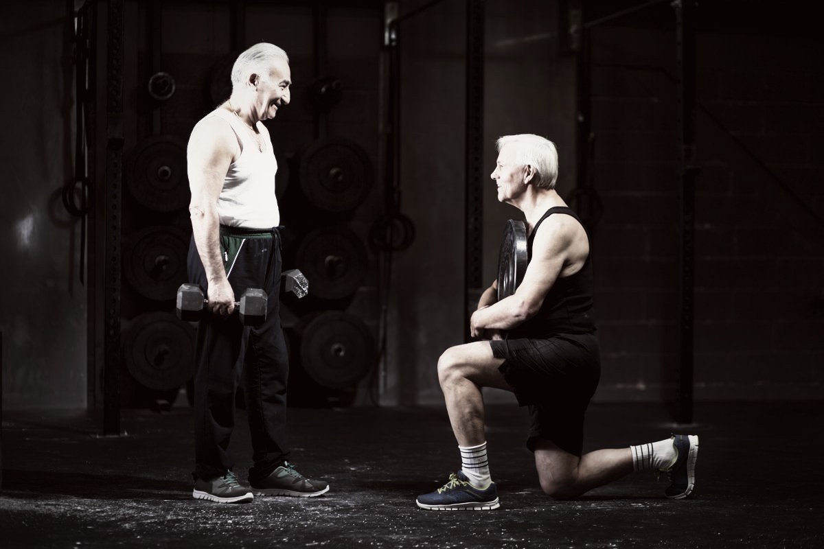 Two older adults strength training with dumbbells