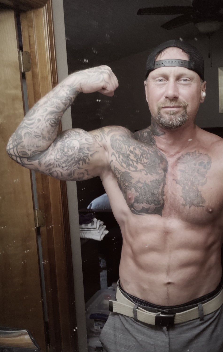Phillip Walsh flexing his bicep, current physique